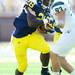Michigan sophomore running back Fitzgerald Toussaint runs the ball past Eastern Michigan defensive lineman Brad Ohrman during the third quarter against Eastern Michigan at Michigan Stadium on Saturday. Melanie Maxwell I AnnArbor.com